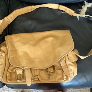 tan DKNY messenger bag